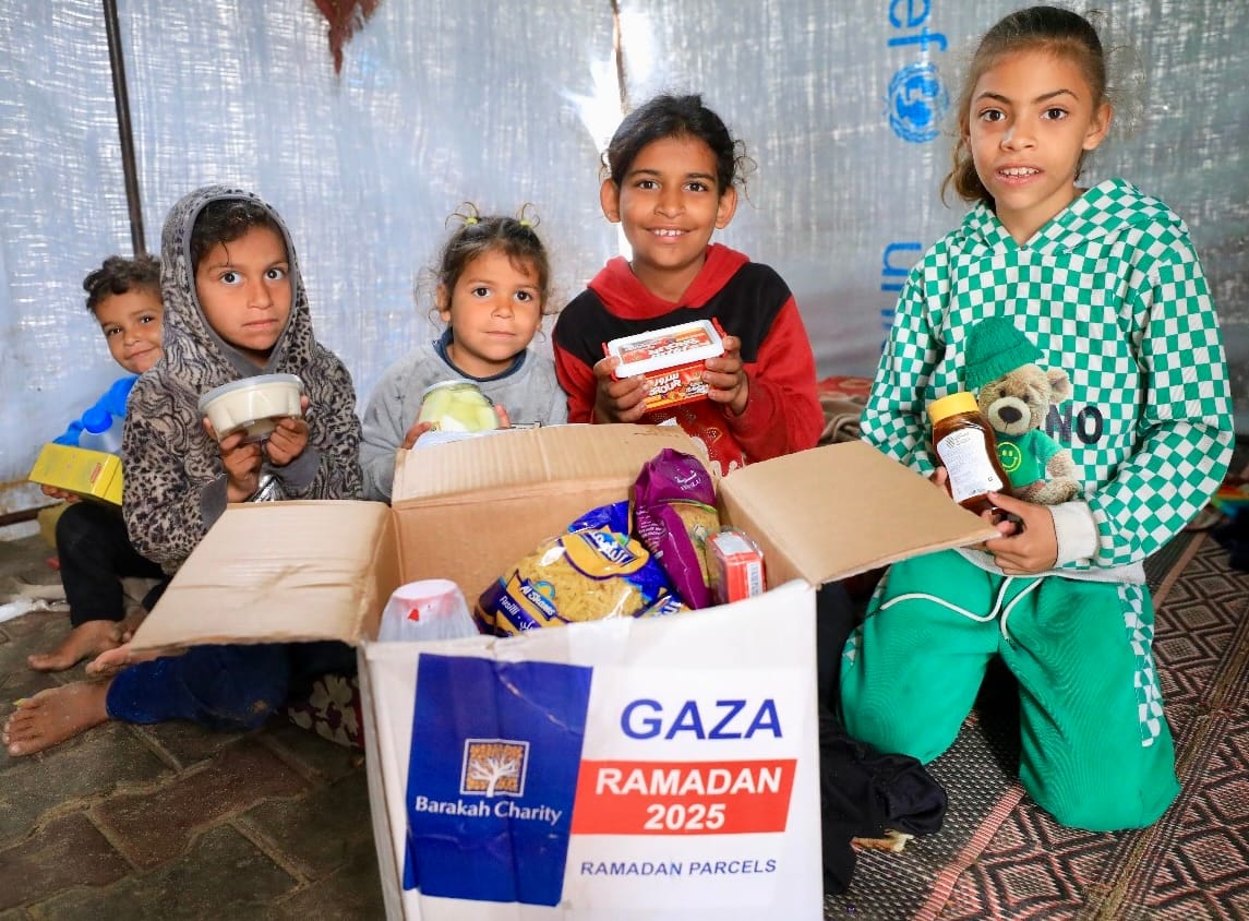 Happy children opening a Ramadan parcel filled with food